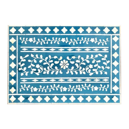 Full flat view of handmade blue floral bone inlay nightstand tabletop showing white flower, vine scroll, diamond border, and leaf garland pattern rows on deep teal blue resin base.