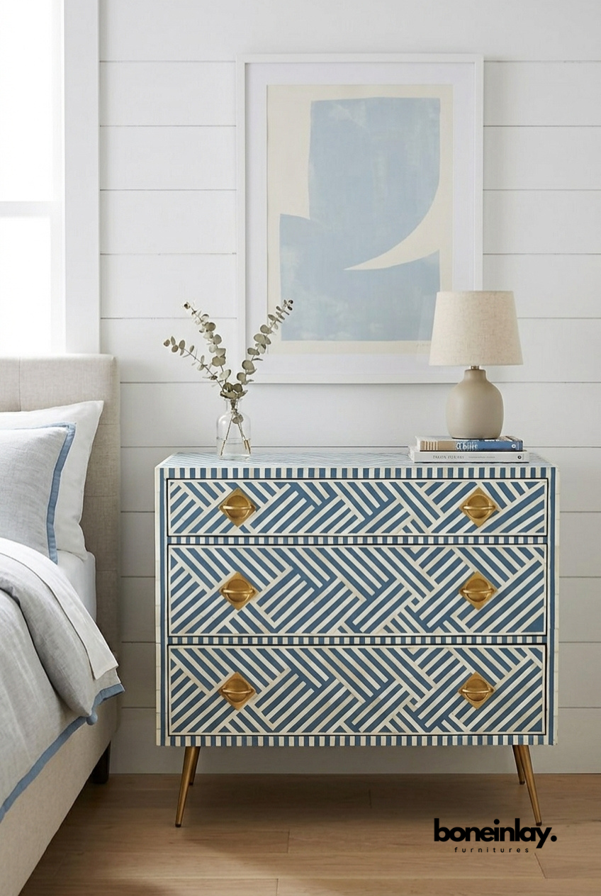 Three-drawer slate blue and ivory bone inlay dresser featuring a geometric optical diagonal stripe pattern, gold diamond-shaped hardware, and gold tapered legs.