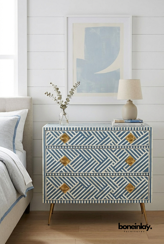 Three-drawer slate blue and ivory bone inlay dresser featuring a geometric optical diagonal stripe pattern, gold diamond-shaped hardware, and gold tapered legs.