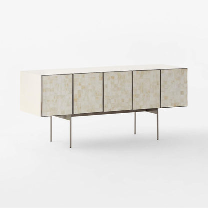Bone inlay carreau entertainment console with one door open revealing interior wooden shelf and storage compartment. Ivory square-tile inlay across all five doors with dark metal frame edging and thin metal legs. Shows ample internal storage capacity for a media unit or living room credenza.