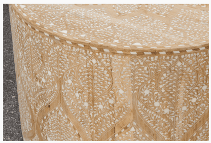Close-up of drum coffee table side panel showing detailed Moroccan arch and vine bone inlay pattern, handcrafted white inlay on natural wood surface
