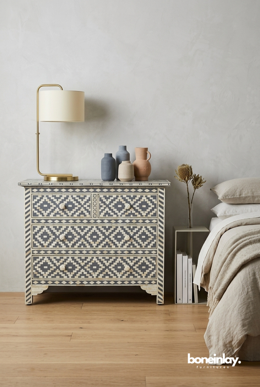 Handmade bone inlay four drawer dresser with grey geometric diamond pattern styled in a bedroom with brass lamp and decorative vases