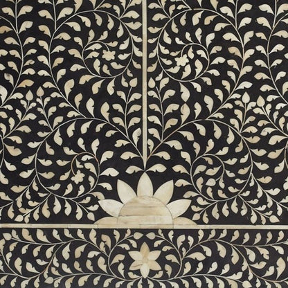 Close-up of handcrafted bone inlay Mehrab headboard showing intricate white floral vine and lotus motif on black mango wood