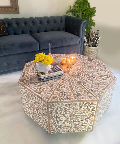 Bone inlay octagonal coffee table with resin finish and all-over leaf pattern in natural ivory and warm gold tones, photographed on plain white background showing full structure
