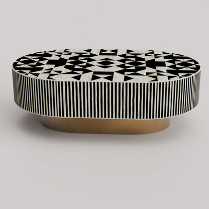 Bone inlay oval coffee table with black white geometric star pattern top, vertical striped apron and gold brass base