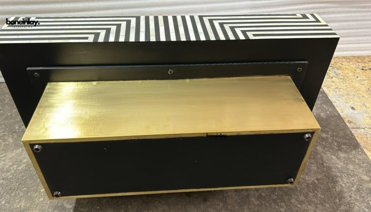 Bone inlay stripe pattern center table showing brass plinth understructure and black metal frame, artisan crafted furniture