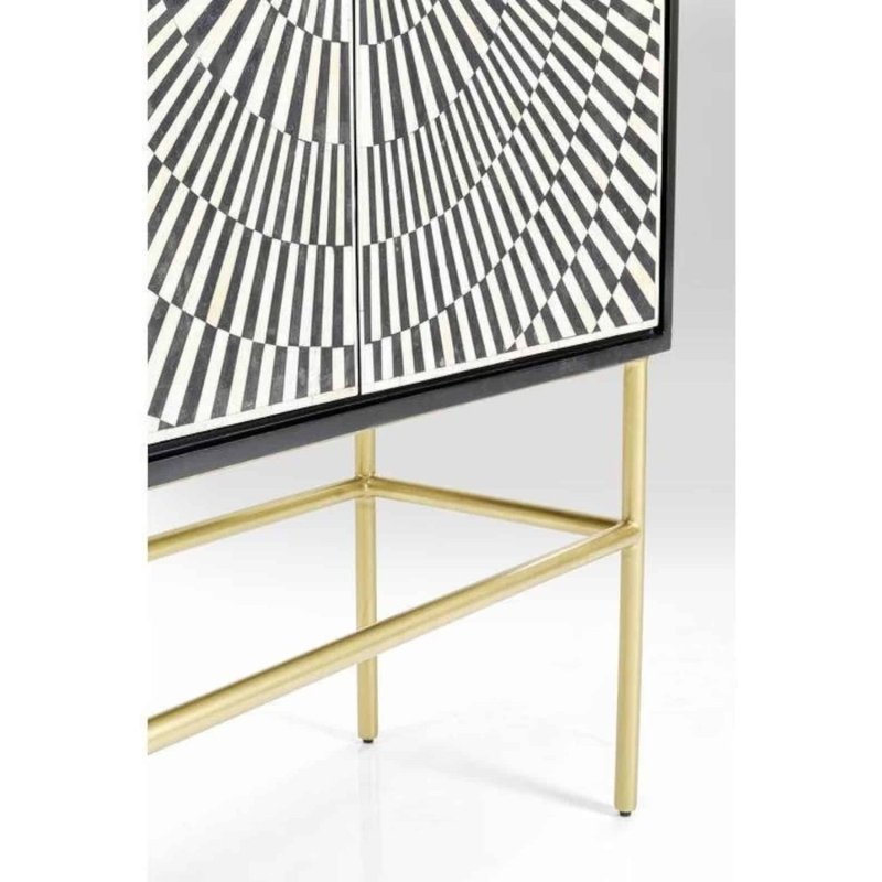 Detail of lower bone inlay sunburst pattern and brushed gold metal base frame of handmade artisan bar cabinet with geometric black white inlay