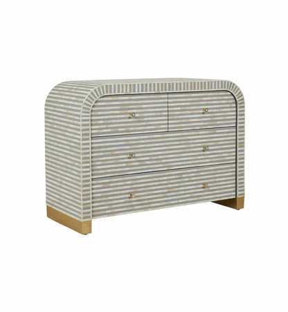 A 4-drawer waterfall-style dresser with a grey and white horizontal striped bone inlay pattern and a gold-finished plinth base.