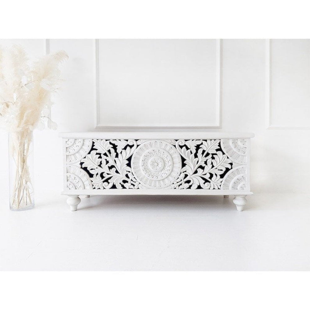 Botanical Wood Storage Chest in white, front view showing a circular floral medallion, leafy cutouts and turned feet.
