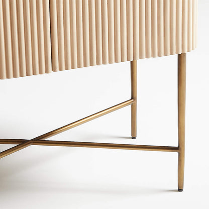 Brass X-leg bar cabinet, close-up of the crossed brass legs supporting the fluted wood cabinet base.