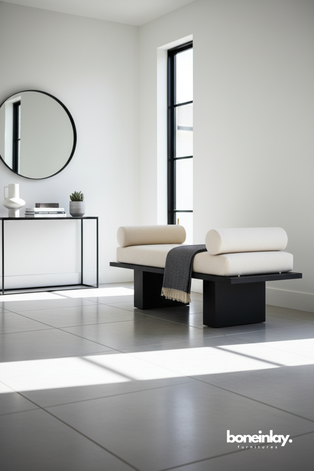 Modern upholstered bench with bolster cushions in a minimalist contemporary interior.