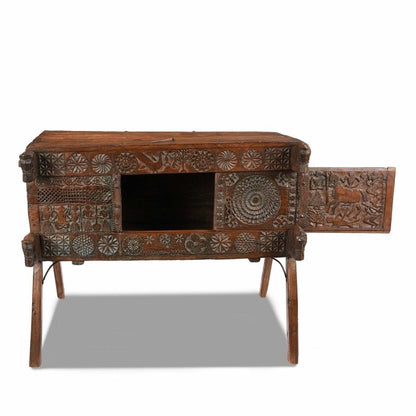 Carved blanket chest in solid wood, front view with the sliding door open to reveal the dark interior.