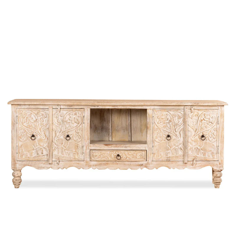 Carved Elephant TV Stand in a front view showing pale wood doors, an open center shelf and a drawer beneath.