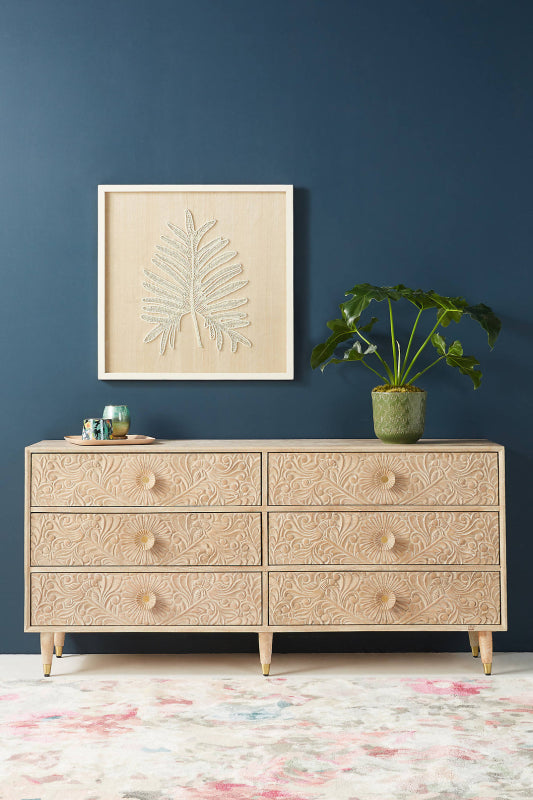 The Gulliver wood bureau has six drawers beneath a straight top, with hand-carved texture on the drawer faces.