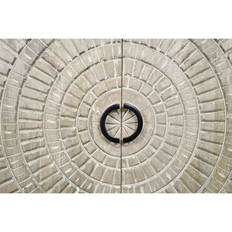 Carved medallion sideboard in pale washed wood, close-up of the circular door carving and ring pull.