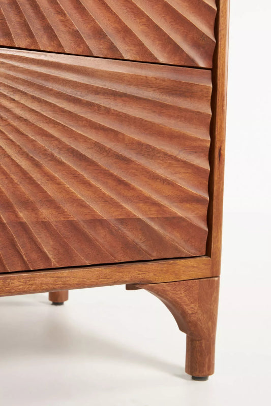 Carved Walnut Dresser shows a close-up of the radial drawer carving and tapered front leg against a white backdrop.