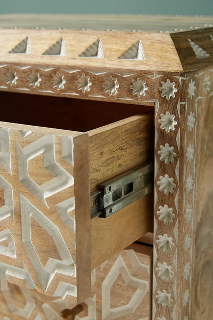 Carved Wood Side Table with drawer open, close-up showing the silver metal slide and carved geometric side panel.