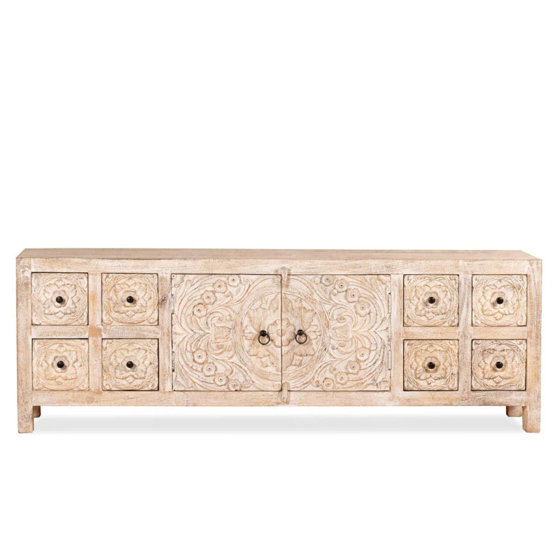 Carved wood sideboard in a front view, showing the low whitewashed cabinet, central doors and rows of drawers.