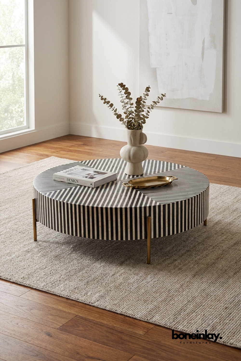 Round black and white striped bone inlay coffee table with brass legs and geometric pattern design