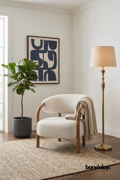 Contemporary boucle lounge chair with rounded backrest, solid wood frame, and textured white upholstery for modern living room seating.