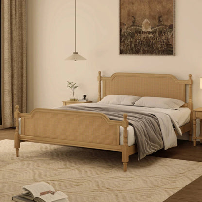 Curved headboard rattan bedstead styled in bedroom, with woven panels, light bedding and a rug beneath the frame.