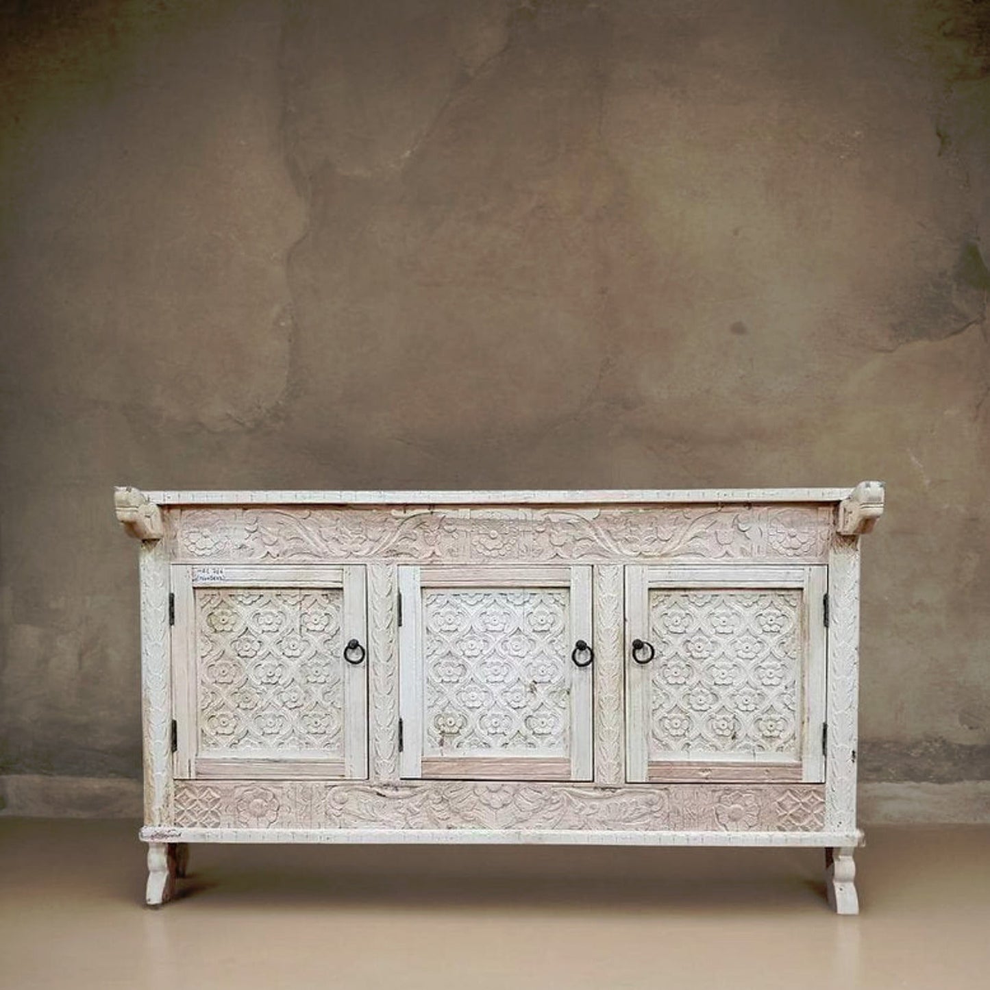 Hand-carved solid wood Indian 3-door Damchiya sideboard with floral trellis panels and iron ring pulls in distressed antique white wash finish.