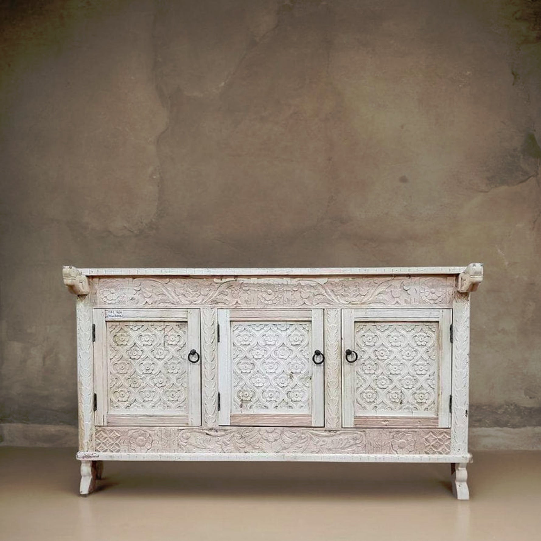 Hand-carved solid wood Indian 3-door Damchiya sideboard with floral trellis panels and iron ring pulls in distressed antique white wash finish.