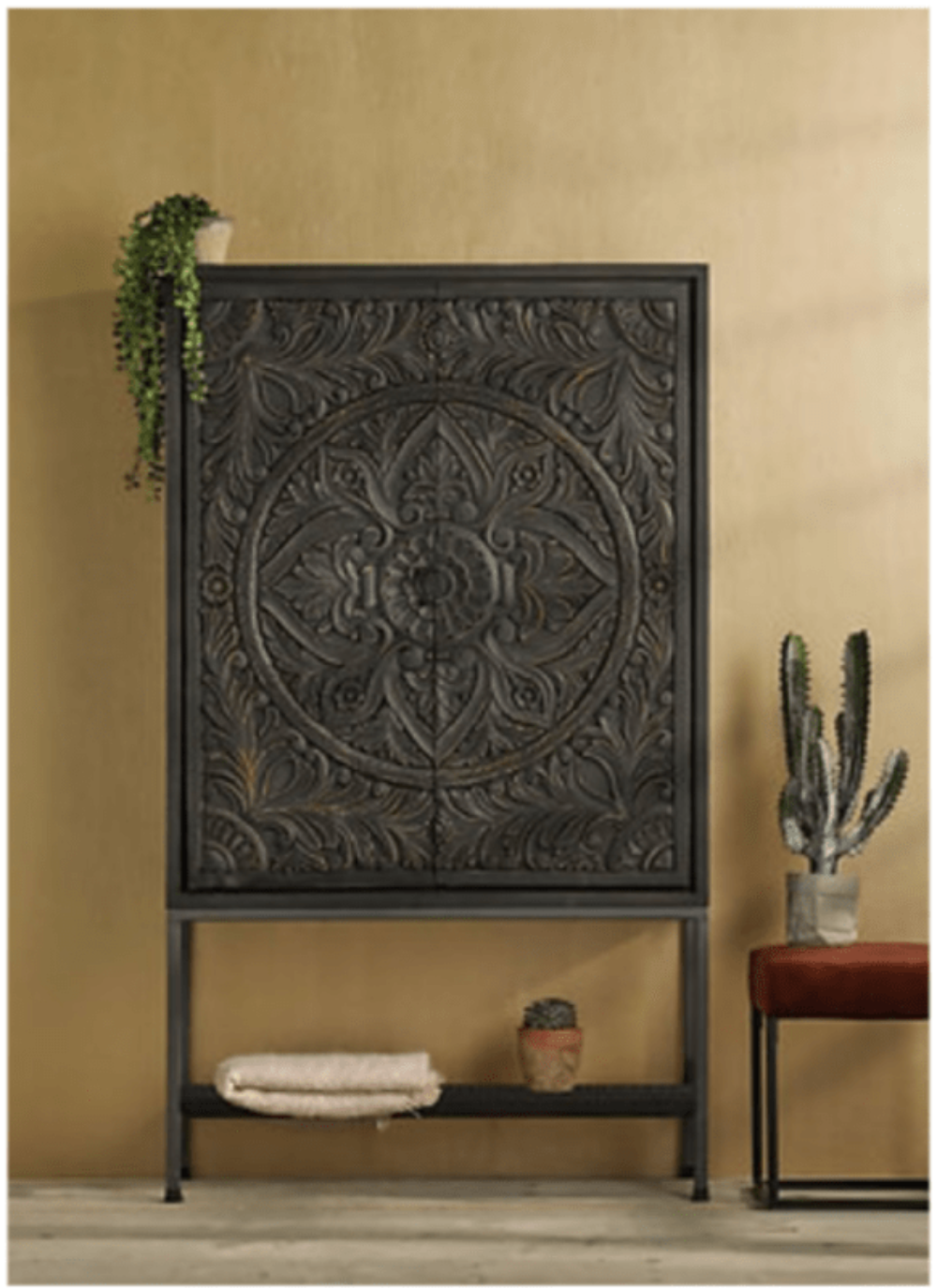 Dark Wood Storage Cupboard, front view in a dim room with its tall doors and open lower shelf visible.