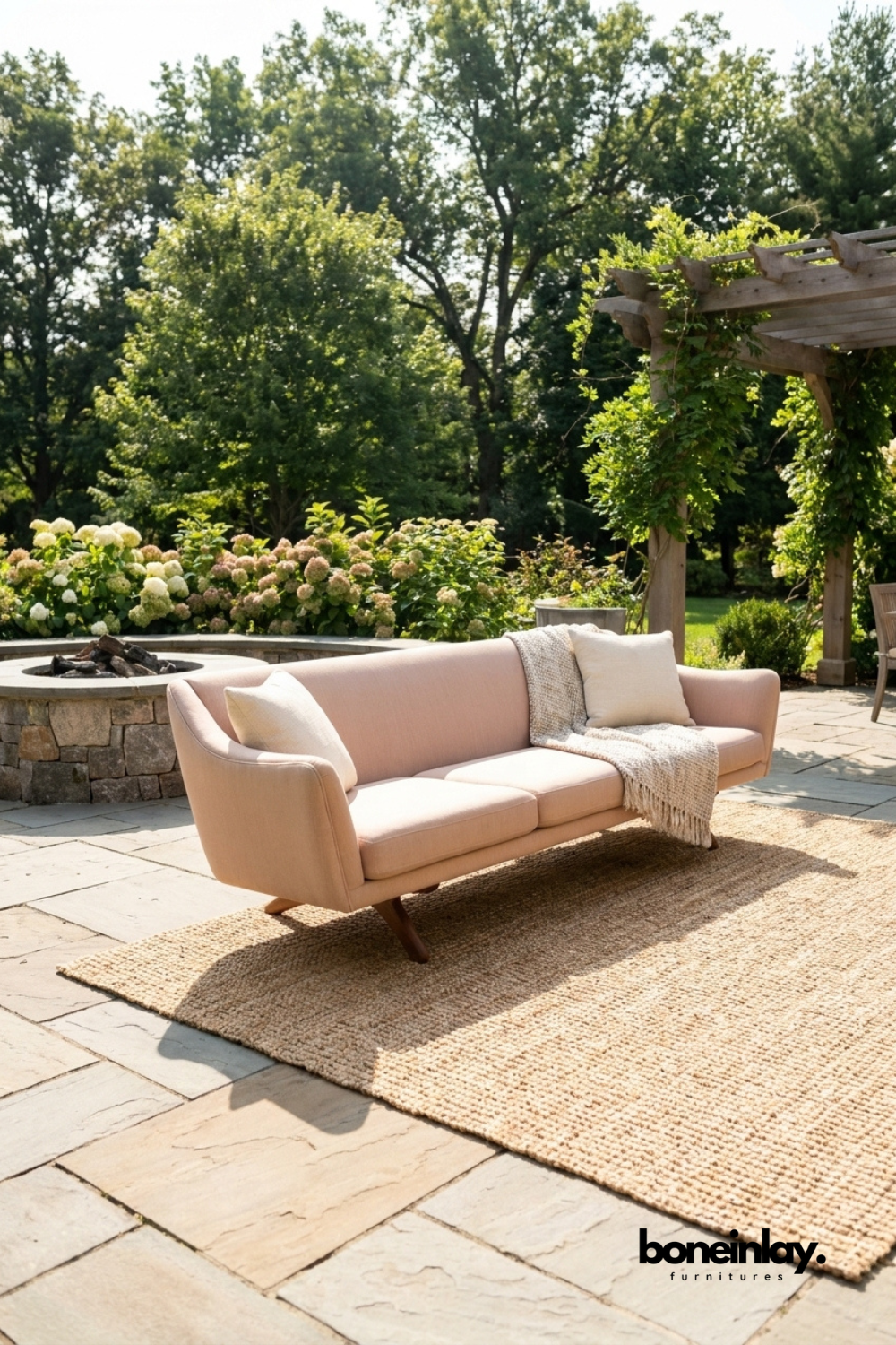Modern blush pink curved upholstered sofa with rounded arms, contemporary fabric three seater couch, luxury living room sofa