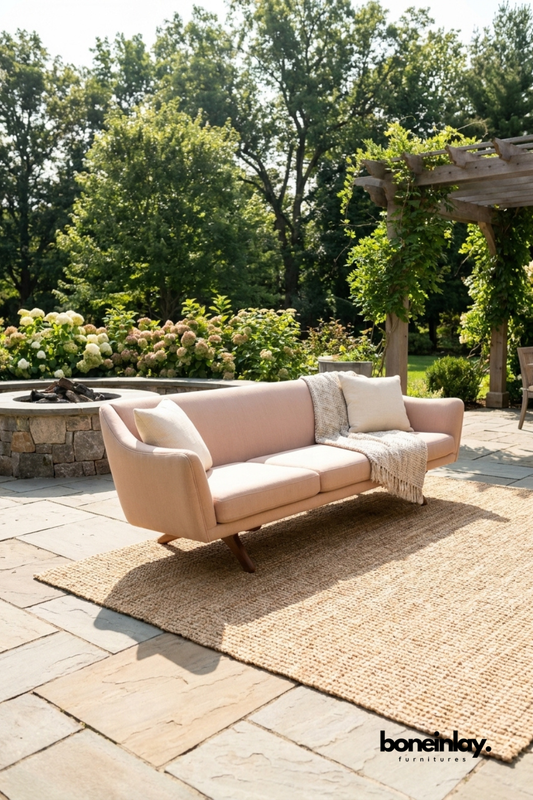 Modern blush pink curved upholstered sofa with rounded arms, contemporary fabric three seater couch, luxury living room sofa