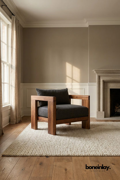 Modern walnut wood lounge chair with charcoal upholstered cushion, contemporary accent chair featuring bold geometric wooden arms and minimalist design.