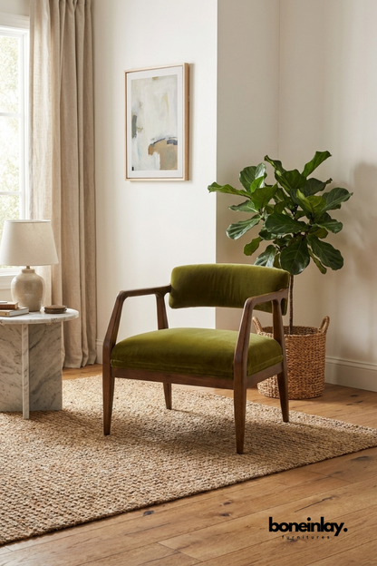 Olive green velvet upholstered armchair with mid-century style dark wood frame