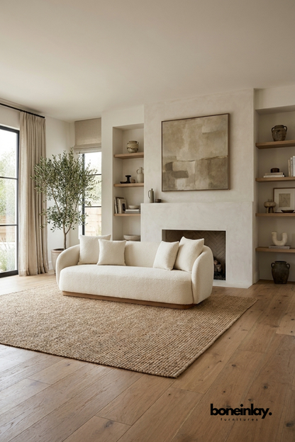 Modern curved boucle sofa with rounded silhouette and cream textured upholstery, contemporary living room sofa featuring soft sculptural design and wooden base.