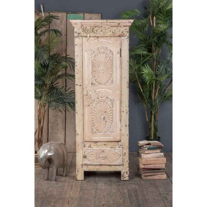 Distressed cream single door storage armoire with paneled door, front view showing carved crown and base trim.