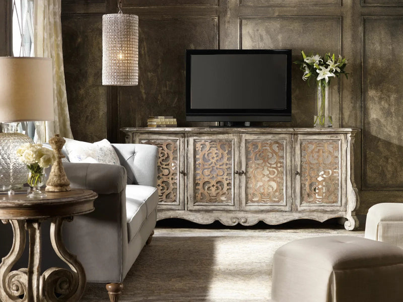 In a furnished room, a white carved credenza sits beneath display shelves, shown from a straight-on front angle