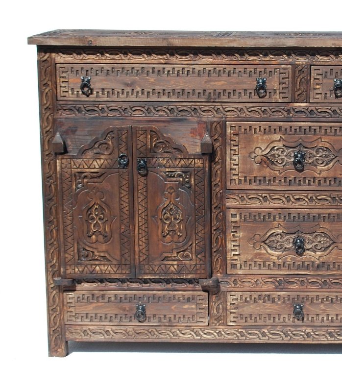 Drop pull wooden buffet in rustic carved timber, cropped front view showing left cupboard doors and central drawers.