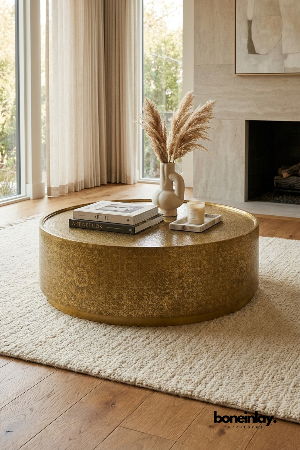 Round embossed brass coffee table with intricate floral engraved pattern and antique gold finish