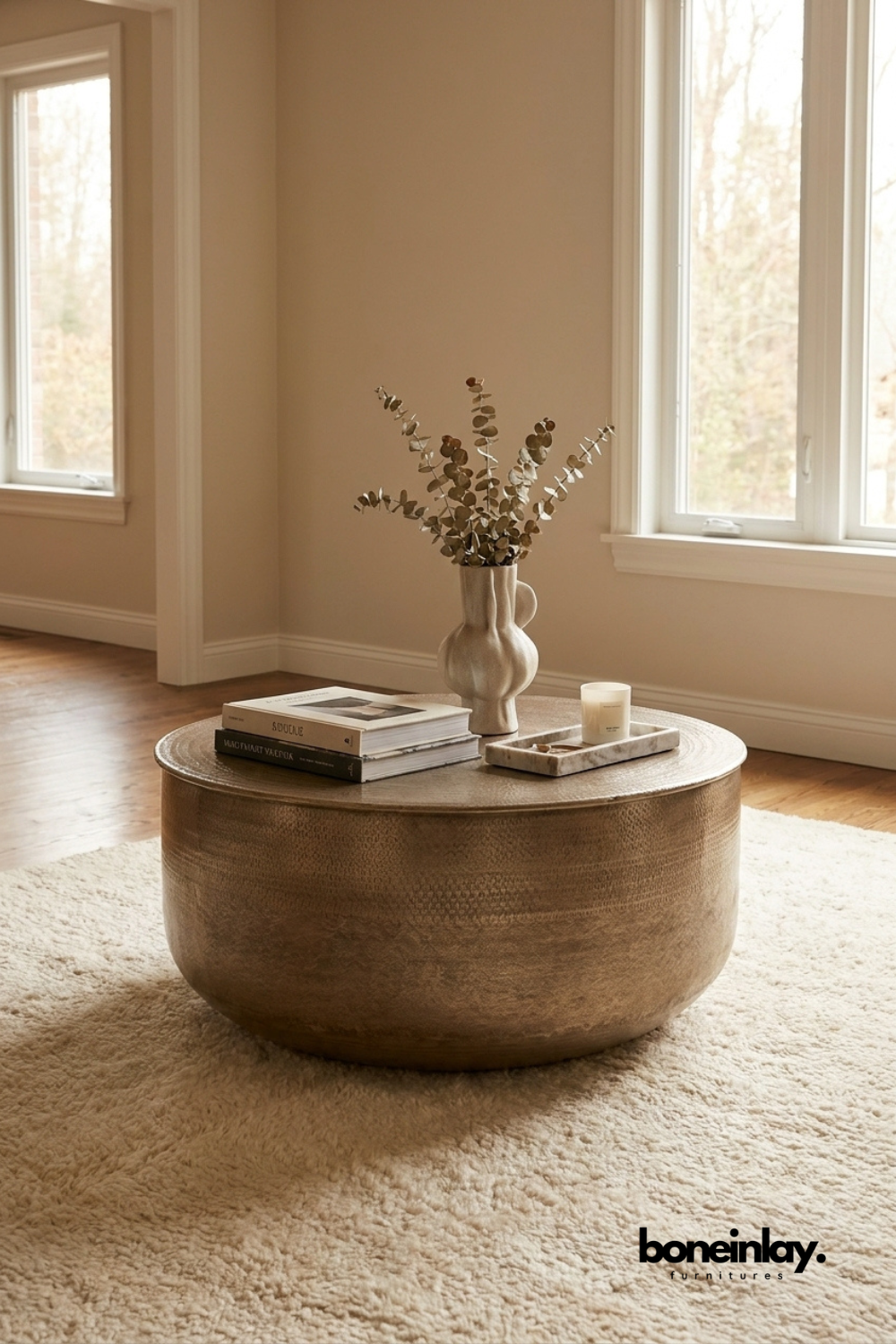 Round hammered copper coffee table with antique metal finish and drum silhouette