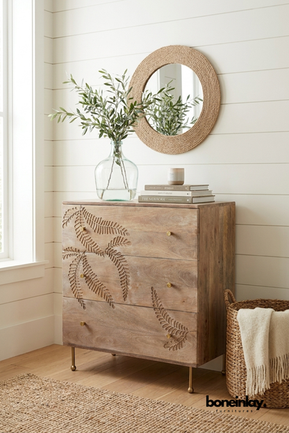 Handcrafted solid wood three drawer chest with carved botanical leaf design, natural finish, brass knobs, and mid-century legs, decorative bedroom storage cabinet.
