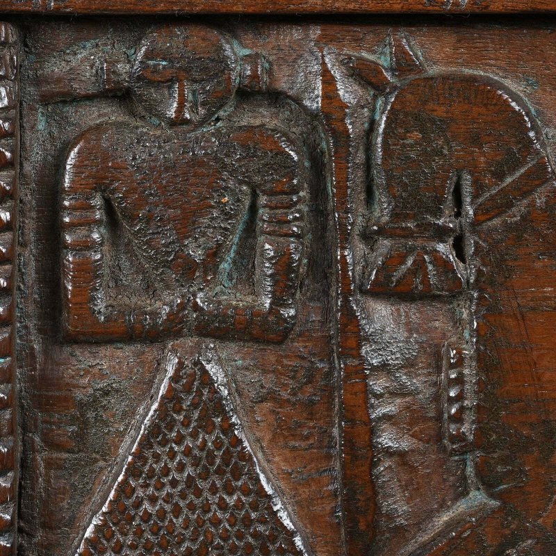 Figure panel damchiya in natural walnut wood, front view close-up showing a carved figure beside the horse.