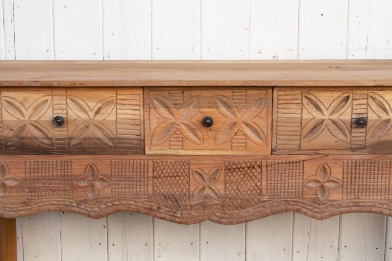 Floral Carved Console Table in rustic solid wood, front view focused on three closed drawers and the patterned apron.