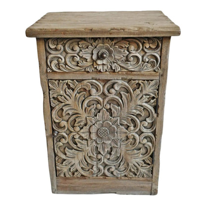 Floral carved end table in rustic solid wood, front view highlighting leafy scrollwork and a round drawer knob.
