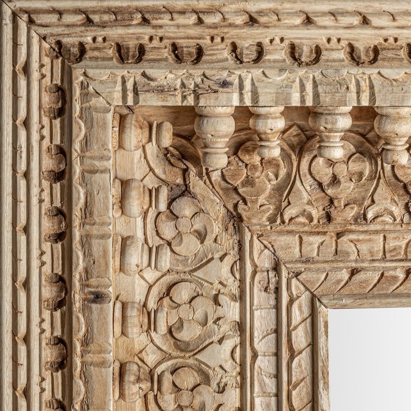 Floral carved wall mirror in rustic solid wood, corner detail view showing layered borders and raised flower motifs.