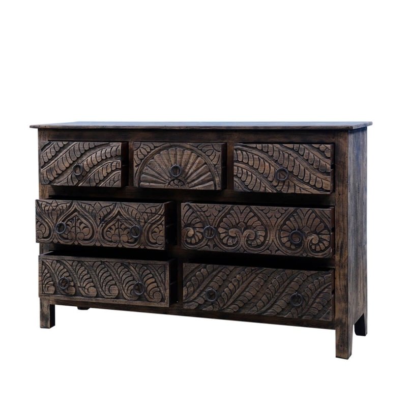 A wood bureau with seven drawers, its dark finish framing floral carving across the drawer faces.