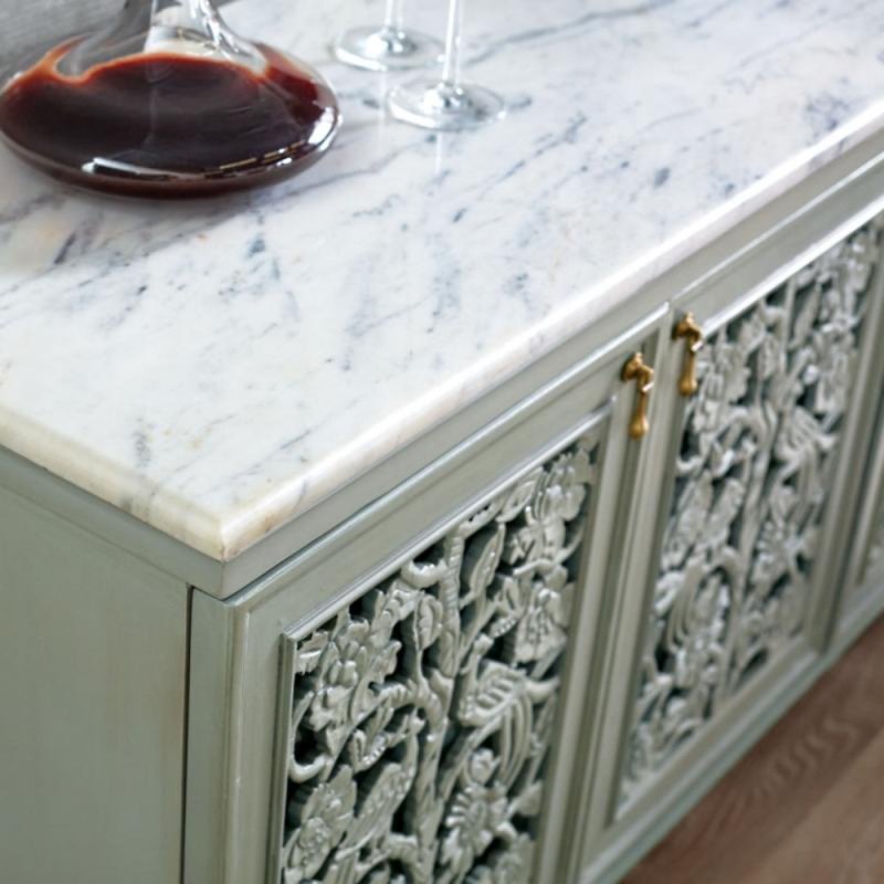 Floral carved wood server with a rustic finish, corner detail view showing the veined white top and decorative door panels.