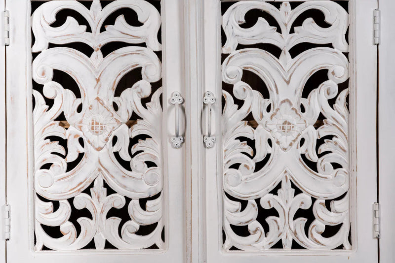 Floral fretwork accent cabinet in rustic solid wood, close-up of drawer handle-style pulls on carved cupboard doors.