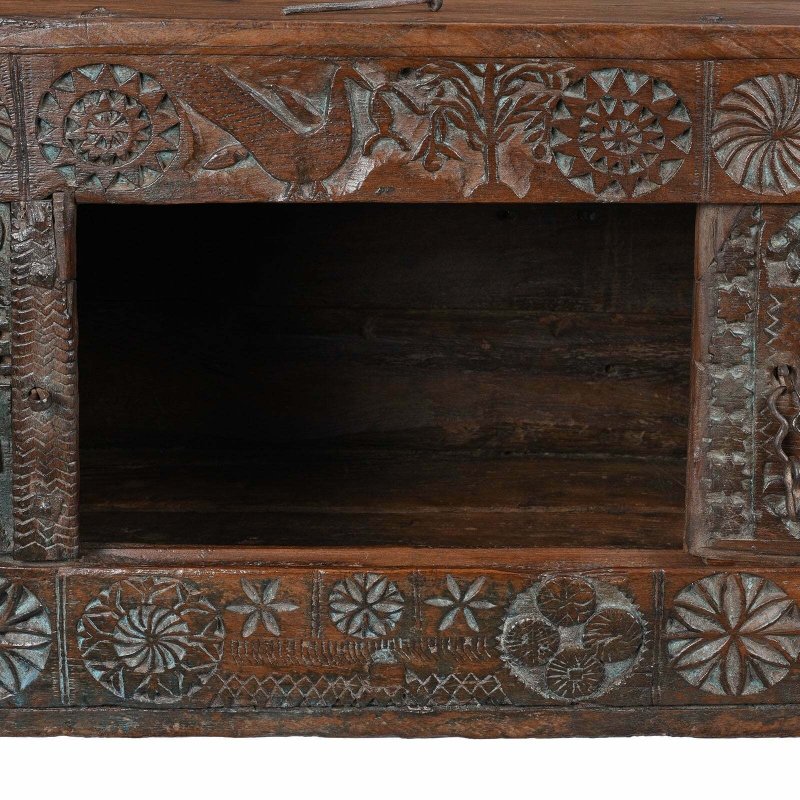 Floral carved hope chest in natural solid wood, front view close-up of the open compartment and patterned frame.