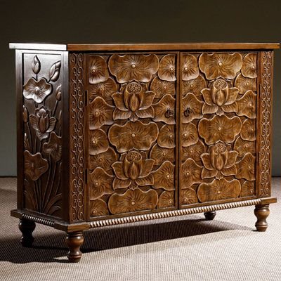 Floral two-door turned-leg buffet in solid wood, front view at a slight angle showing the carved left side panel.