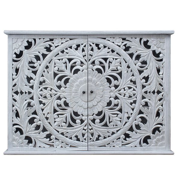 Floral wooden sideboard in rustic, front view showing two carved doors with a circular flower motif.