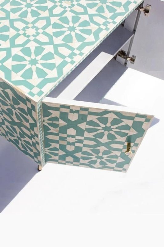 Seafoam green bone inlay four-door sideboard with all doors open showing two interior shelves on each side and brass legs